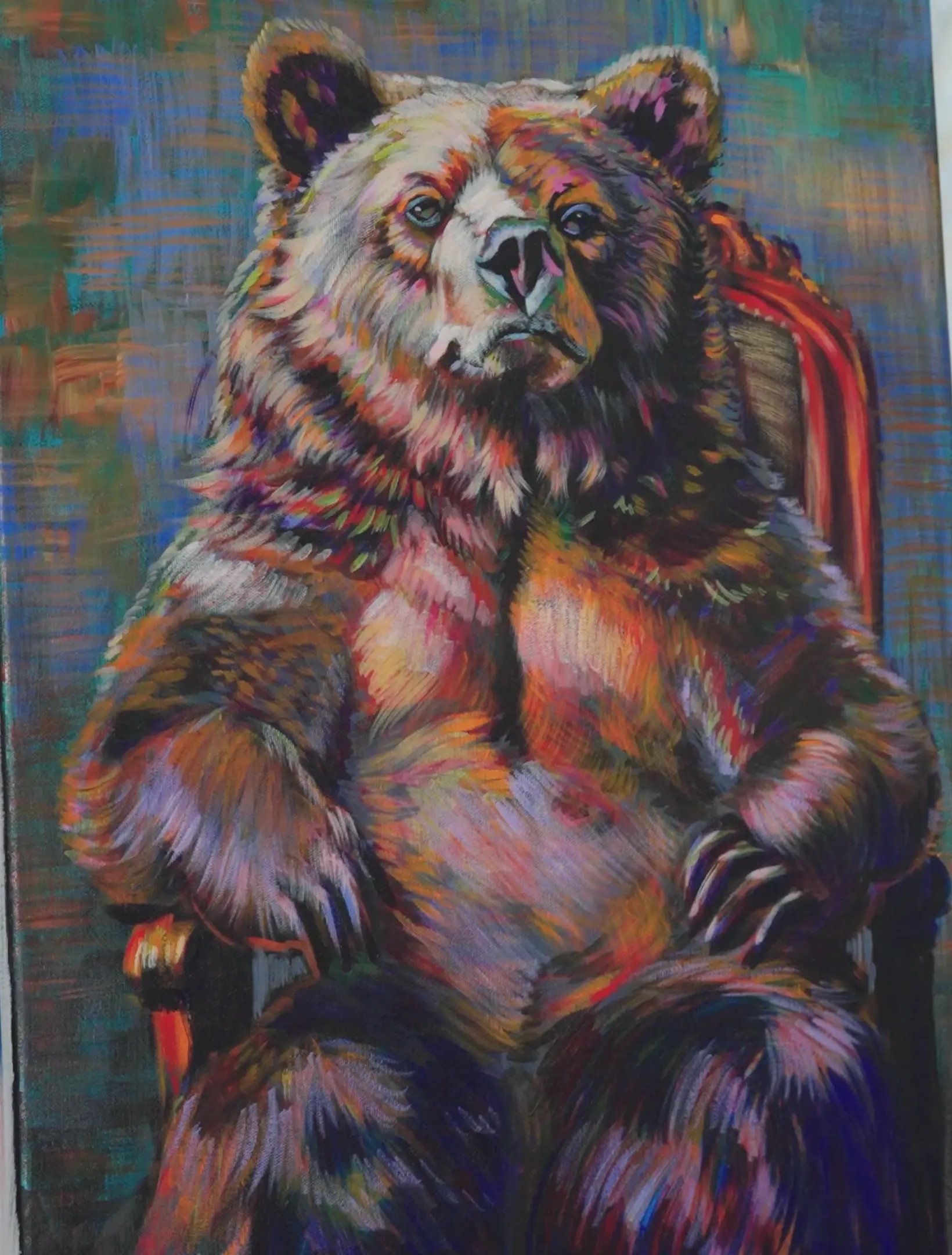 The finished acrylic painting of a bear sitting in a red chair, built from strokes of pure color