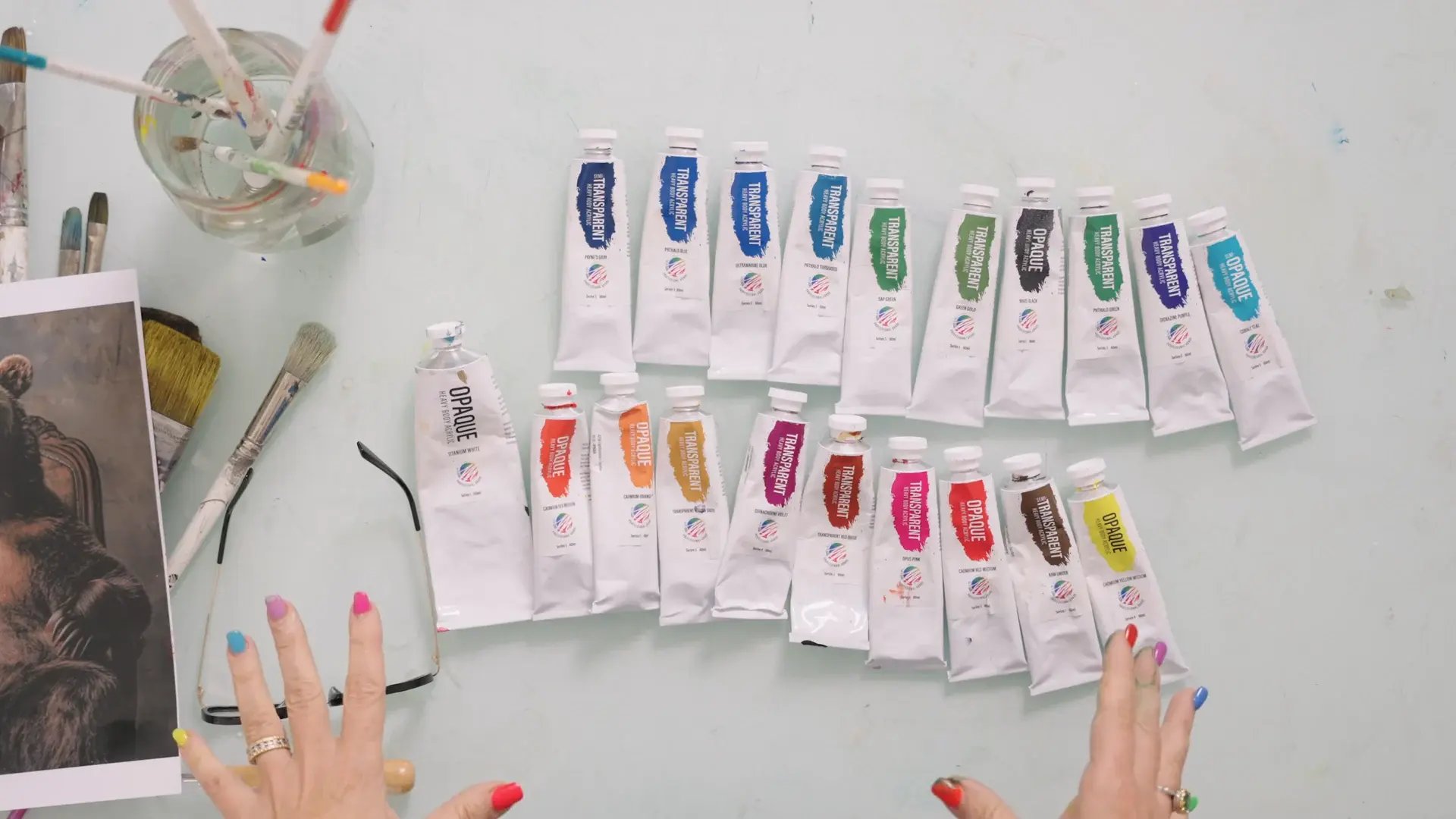 Rows of bright acrylic paint tubes