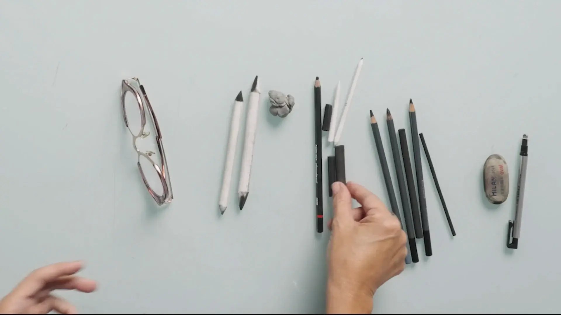 Charcoal sticks, charcoal pencils, a blending stump and a kneaded eraser