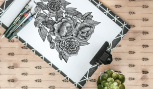 Black pen sketch of roses on a clip board