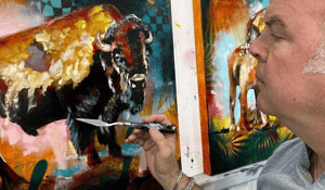man painting with pallet knife a black bison yellow teal background 