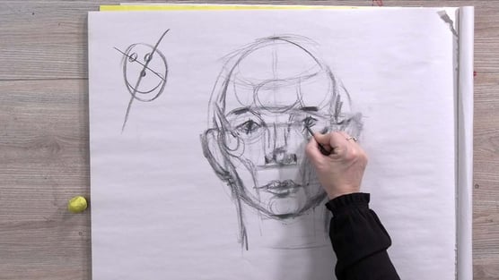 Hand drawing a face on paper