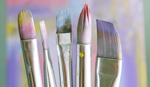 paintbrushes with purple blue paint