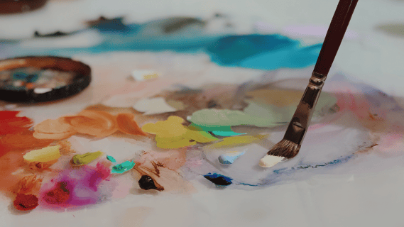 paintbrush on colorful pallet 