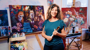 Woman standing confidently in front of paintings