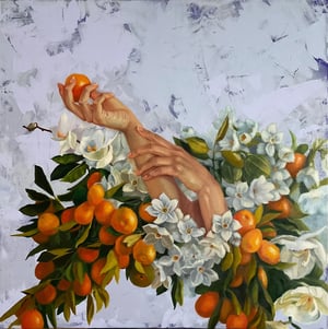 Hands holding oranges surrounded by oranges