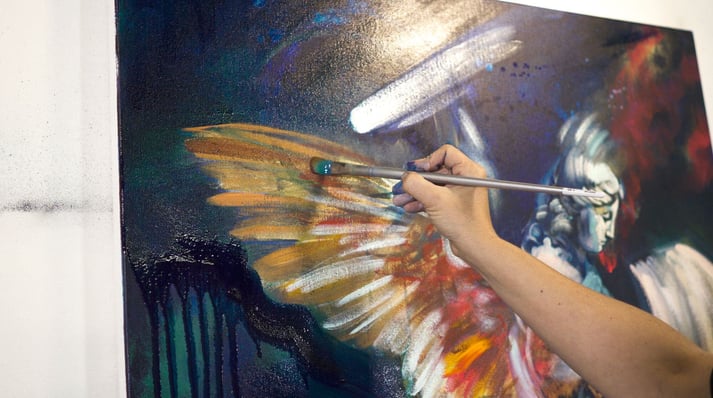 Elli Milan painting angel ble background gold wings with red accents 