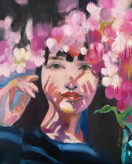 portrait of woman with shadows on her face pink flowers above