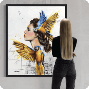 Woman standing in front of painting of woman of two yellow blue birds