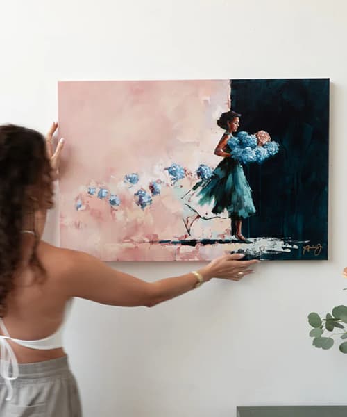 artist putting up painting of girl in blue dress hold flowers