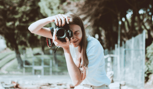 Woman using canmera pointed at viewer