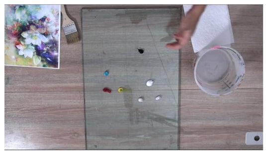 pallet with paint and bucket of water