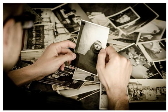 man holding black and white photos