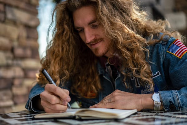 Man writing in journal