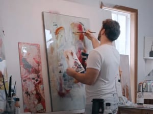 man painting in studio white shirt