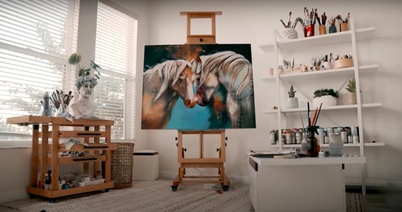 white room with horse painting easel white shelf and work table