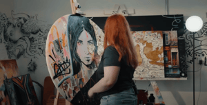 girl standing in front of portrait painting black and white and pops of color