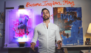 man standing in front of canvases