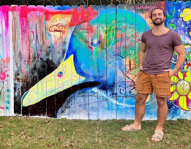 Jake Dunn in front of art mural