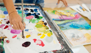 pallet of oil paint with mixed colors yellow green blue