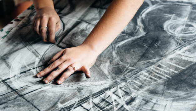 hands drawing on paper guitar