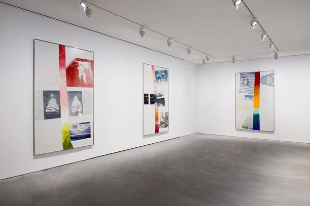 Robert Rauschenberg painignts in a gallery with bold bright colors