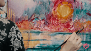 painting of red and yellow and teal brush strokes on canvas