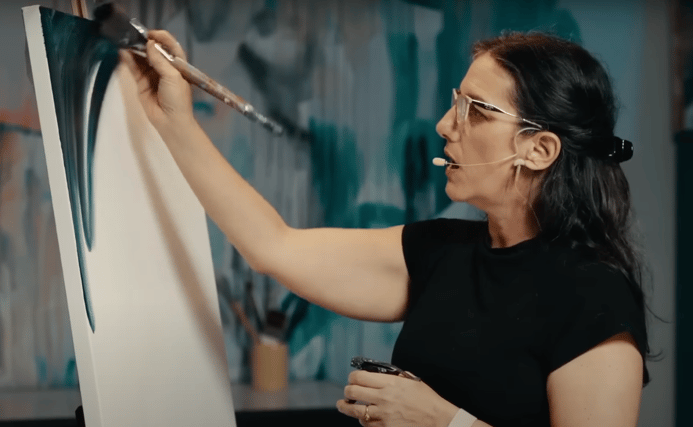 Woman standing in front of canvas