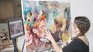 Woman working on unfinished painting