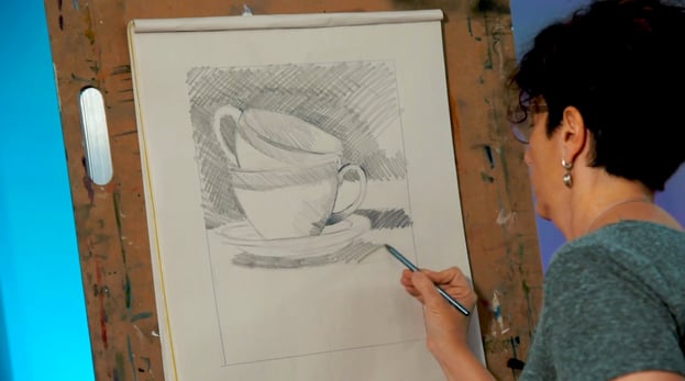 woman drawing tea cups on drawing board