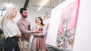 girl standing in front od art smiling with man