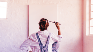 Woman standing in front of blank canvas