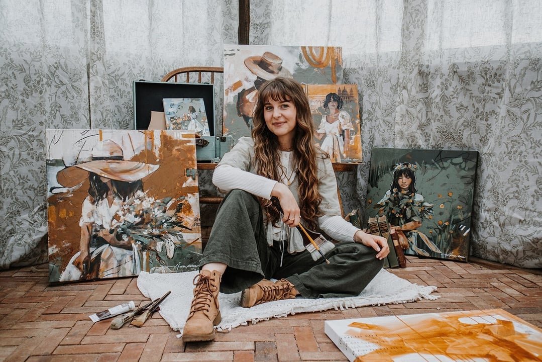 Aleah Danae with her figure paintings