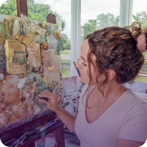 girl sitting in front of canvas with shells collage 