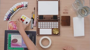 Overhead shot of desk with watercolor supplies