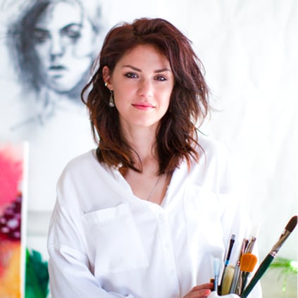 Rita artist sits in front of portrait drawing