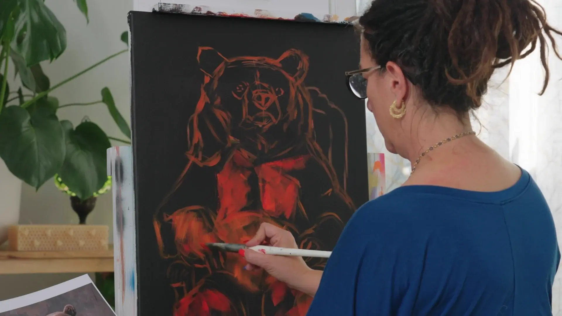 Elli blocking in red and orange on the bear drawing