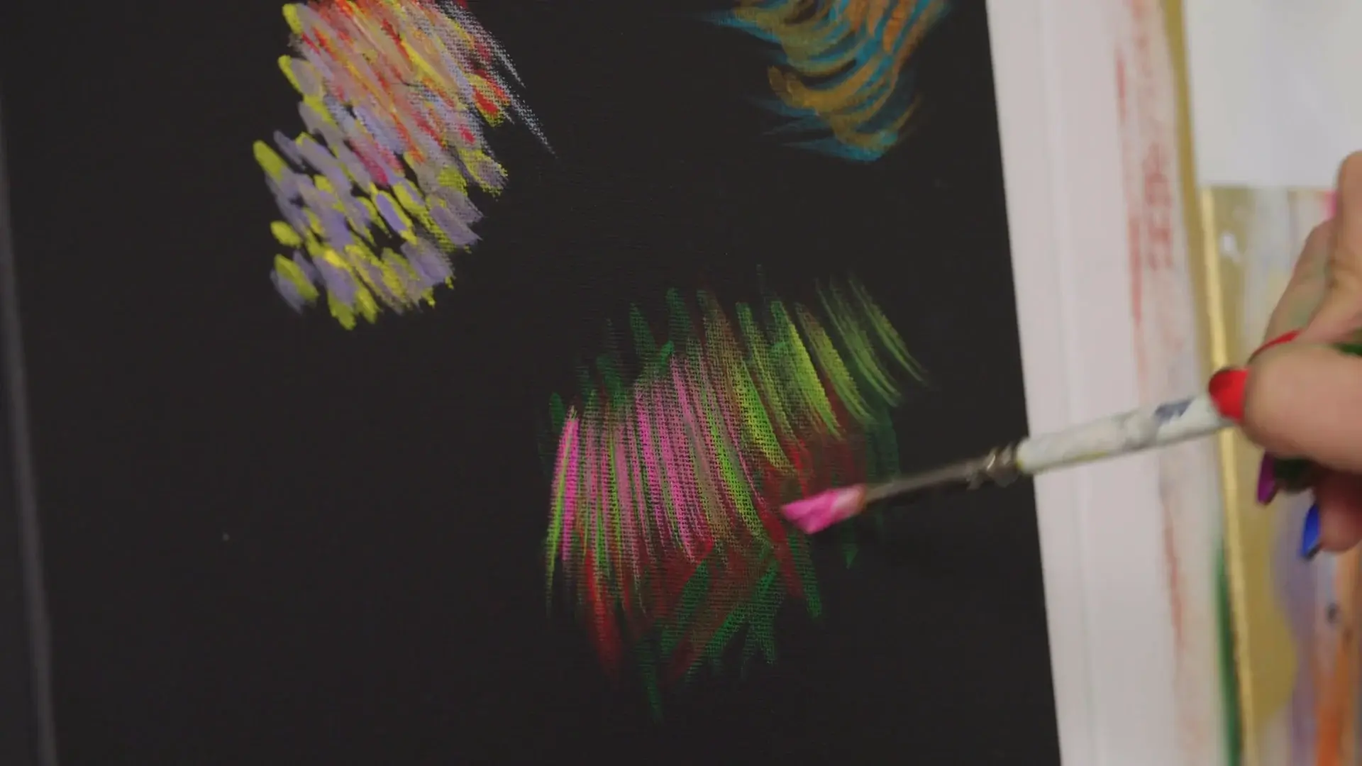 Warm-up strokes of pink, green, yellow and violet side by side on black