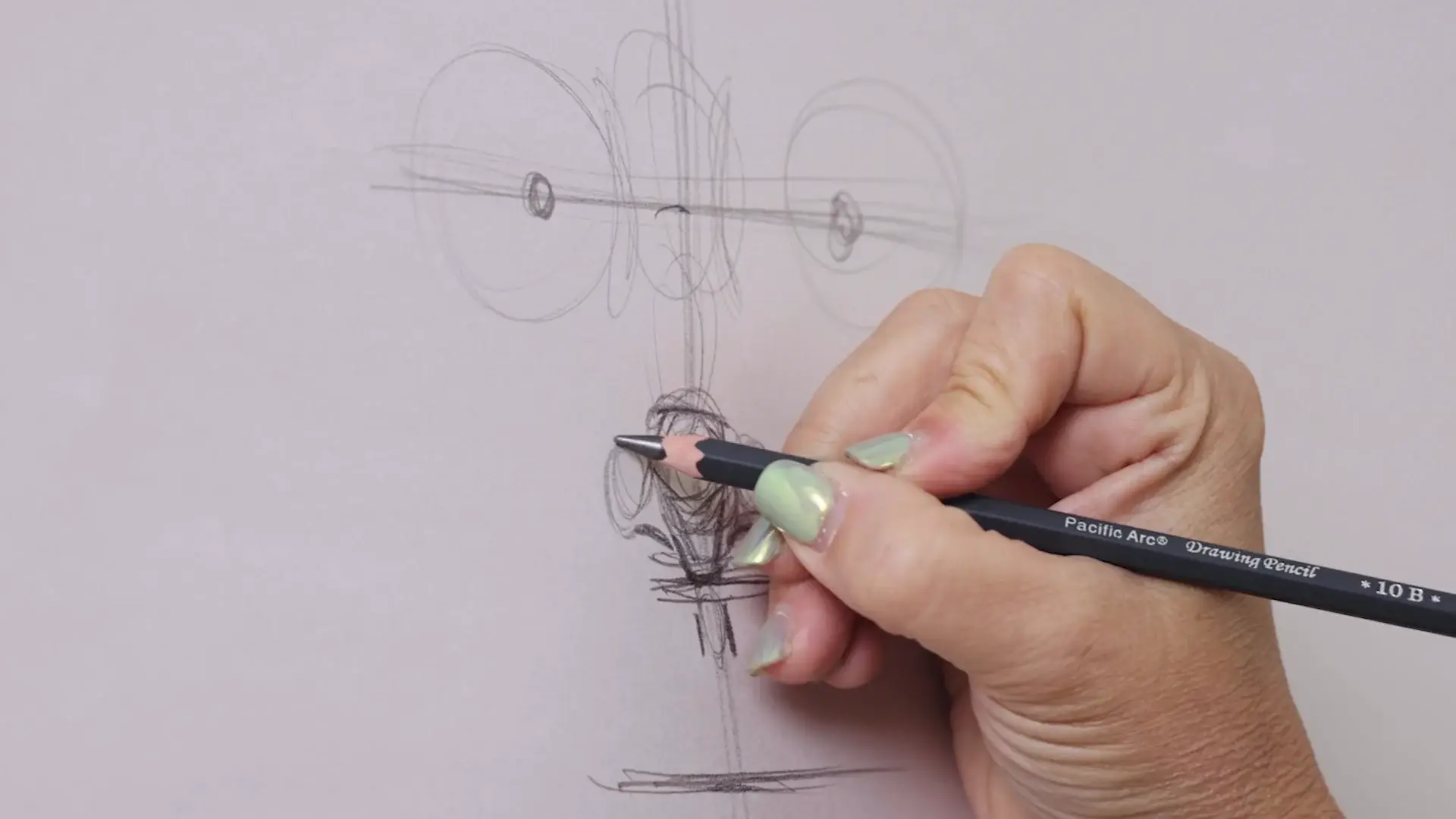 A pencil drawing the nose over light proportion guide lines