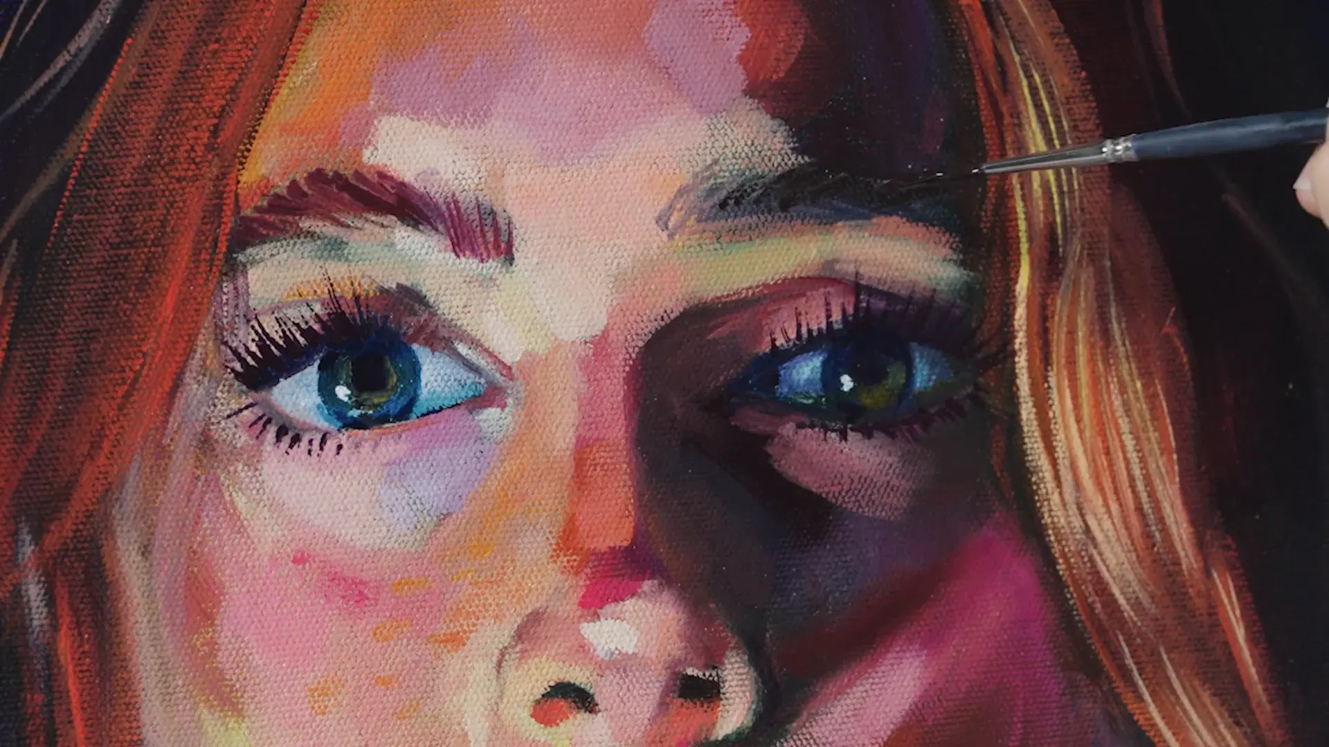 The finished painted eyes and brows, a fine brush adding a last stroke to the hair