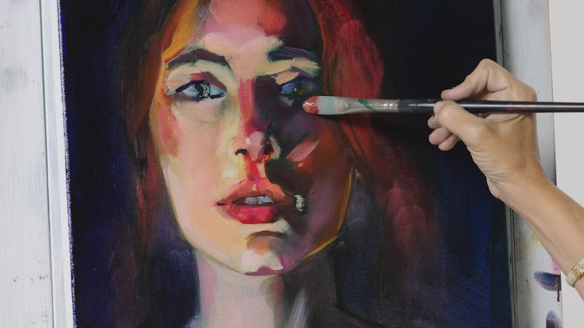 The face built in broad planes of warm color, a brush at the eye