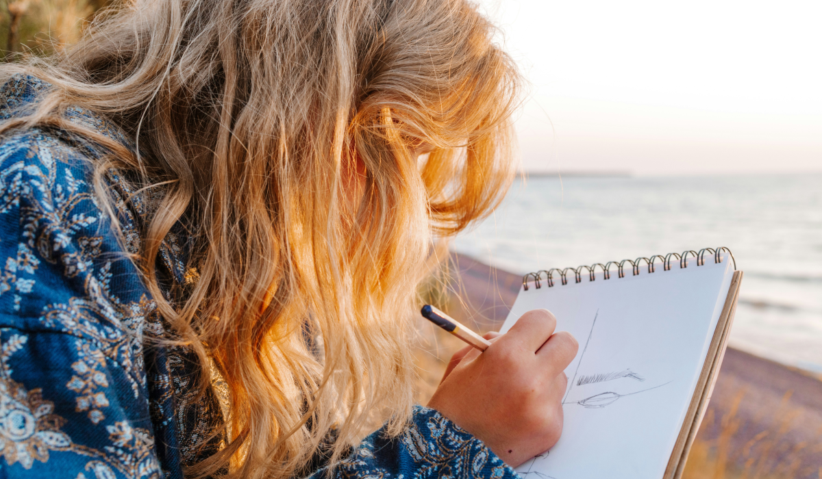 Woman sketching at the beach