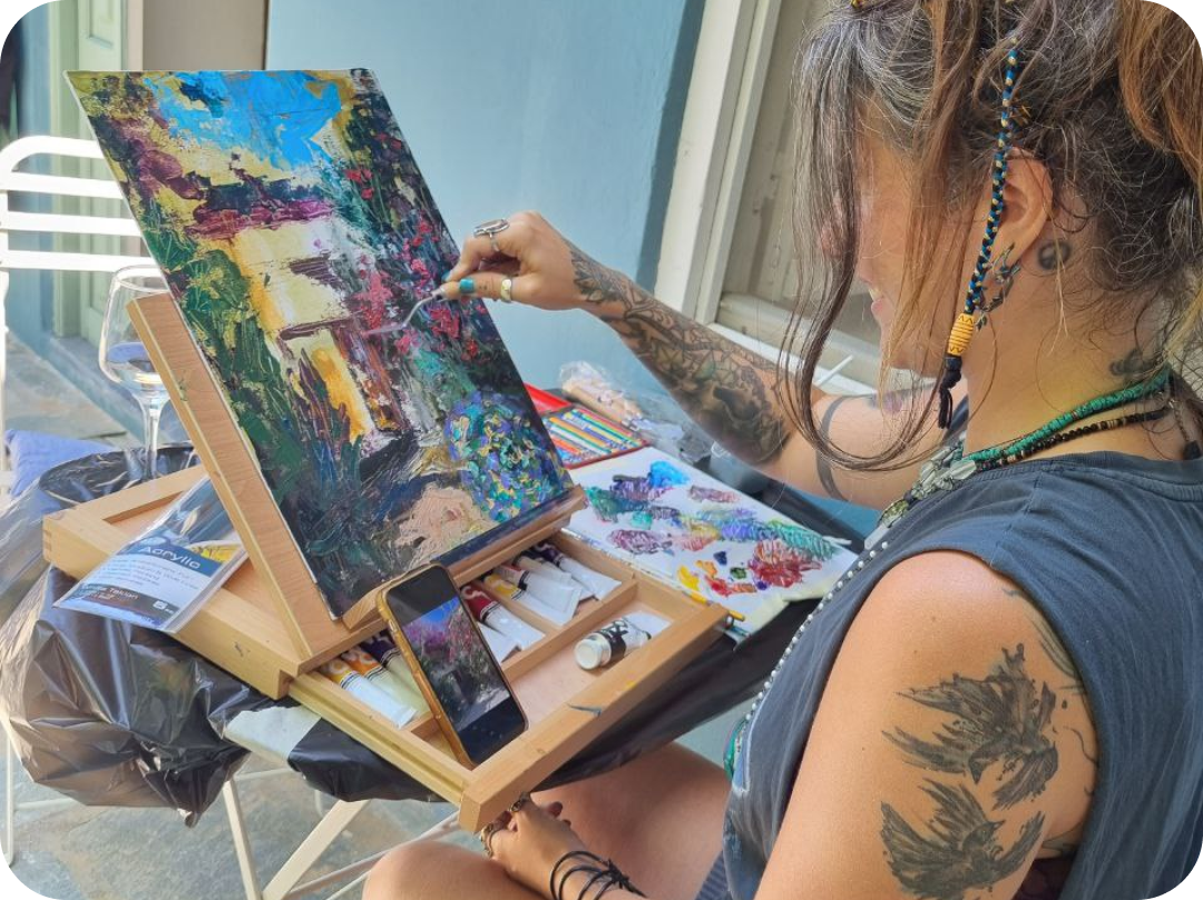 Woman painting landscape using pallet knife