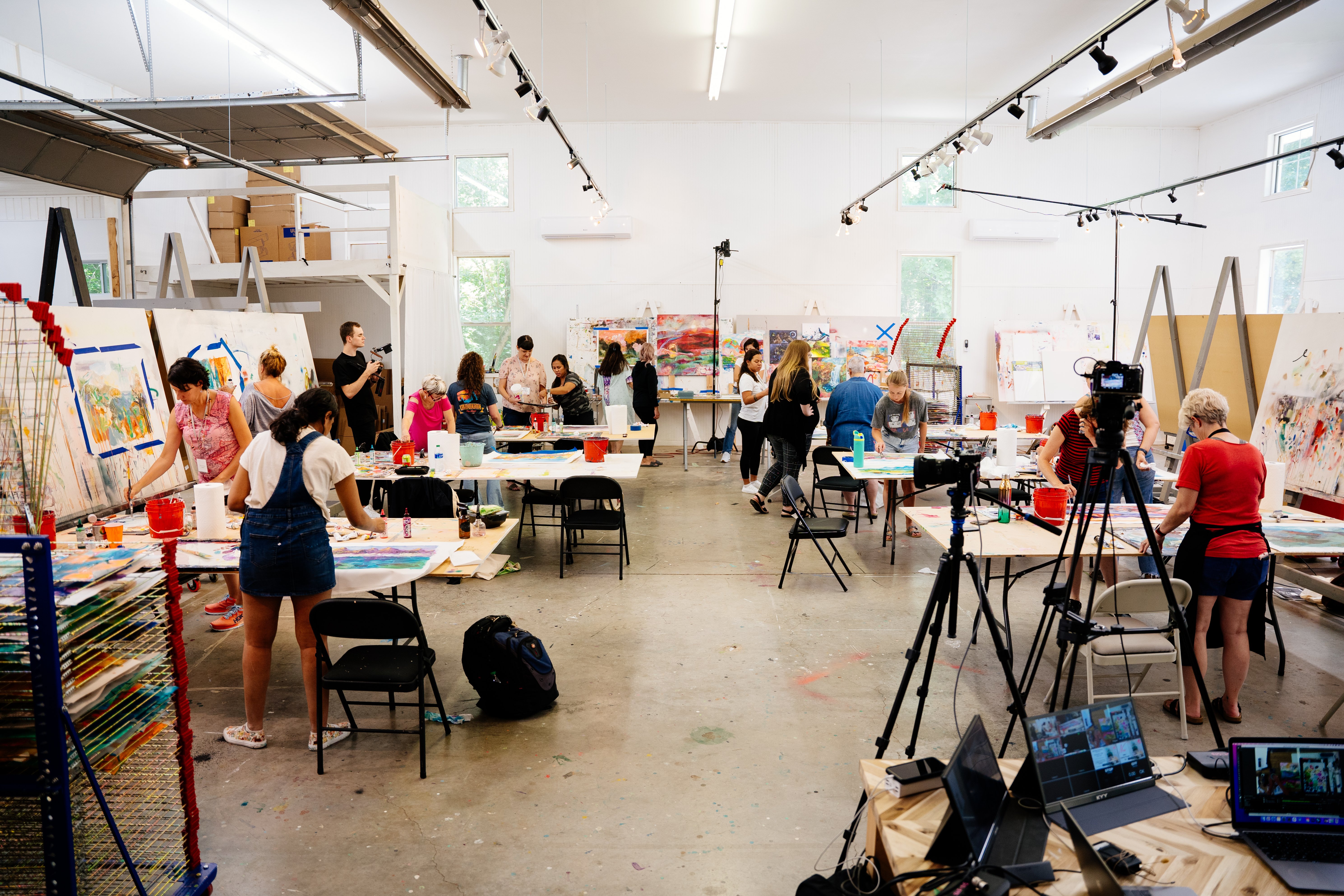 Classroom with students painting on tables and easels