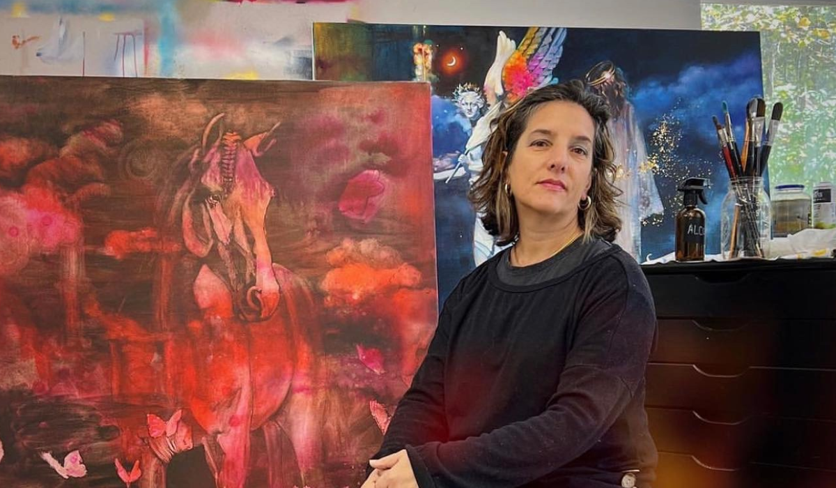 Woman standing in fornt of red horse painitng