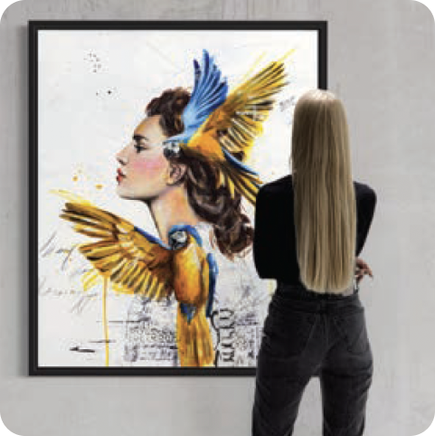 Woman standing in front of painting of woman of two yellow blue birds