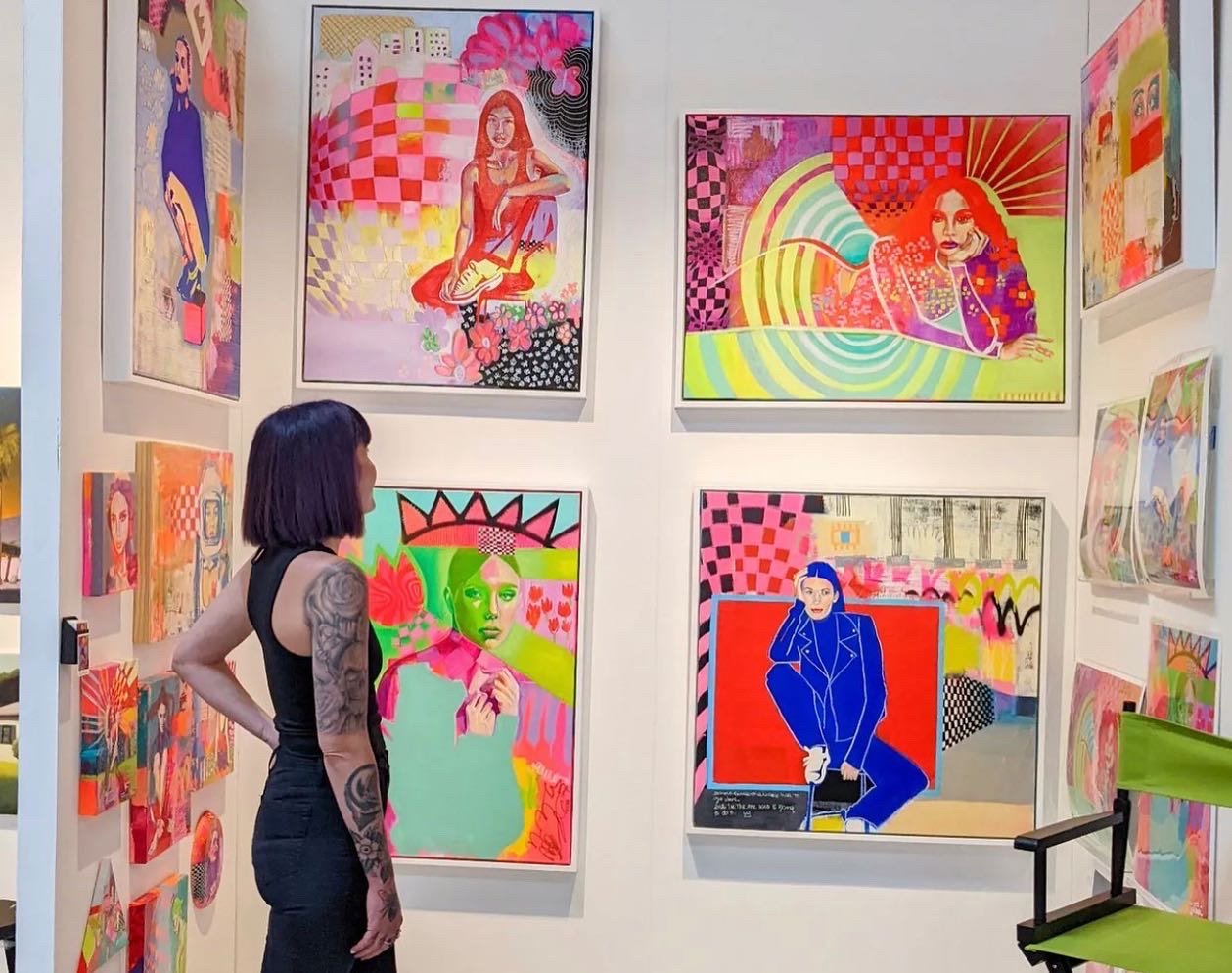 Photo Credit: Milan Art, short-haired women with tattooed arm looking up at bold-colored canvases or women posing in different positions surrounded by shapes