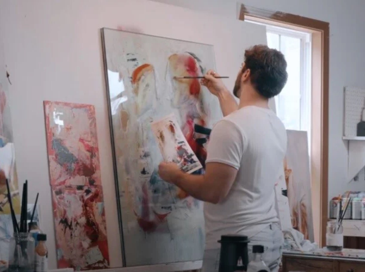 man painting in studio white shirt