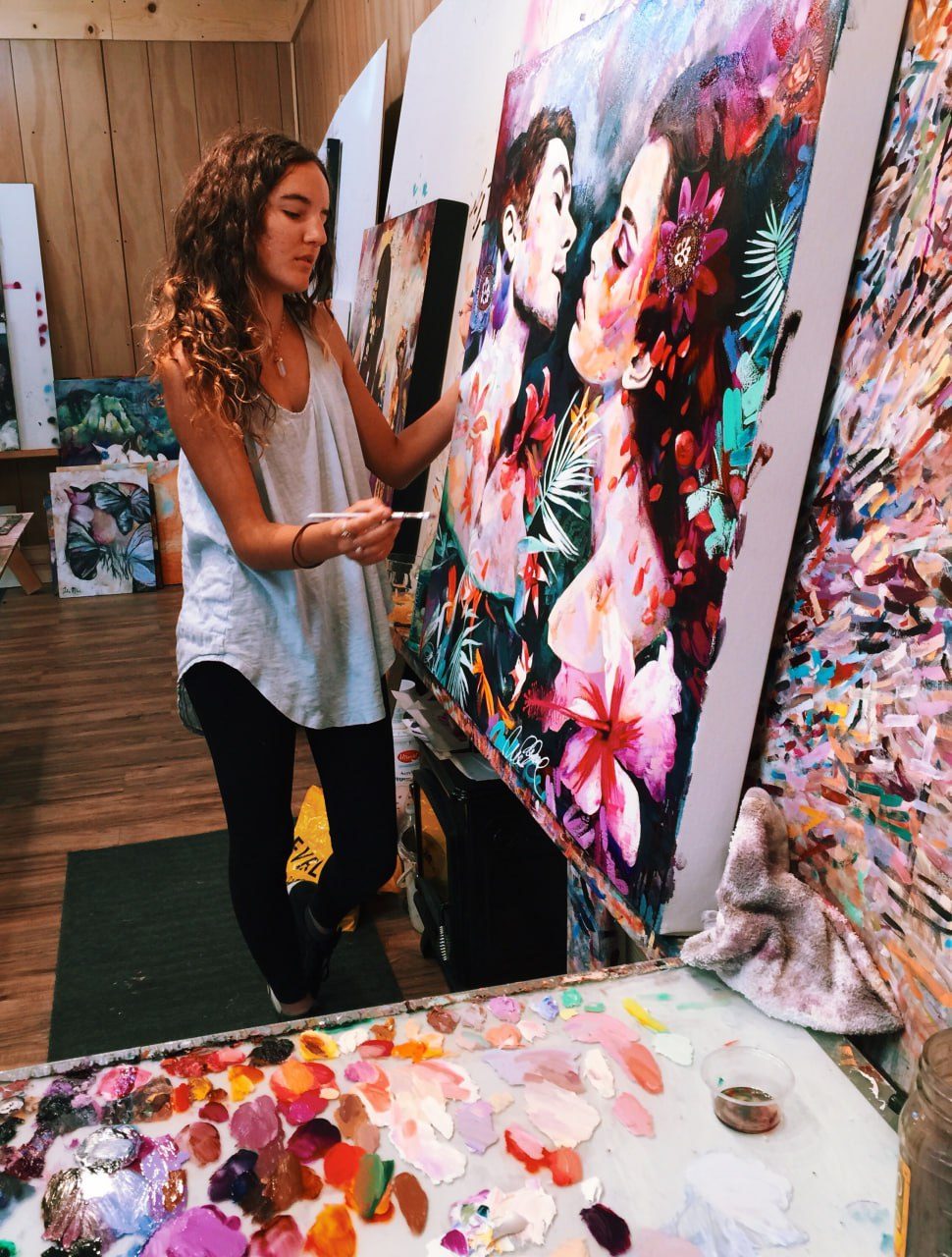 Dimitra Milan painting a large floral canvas