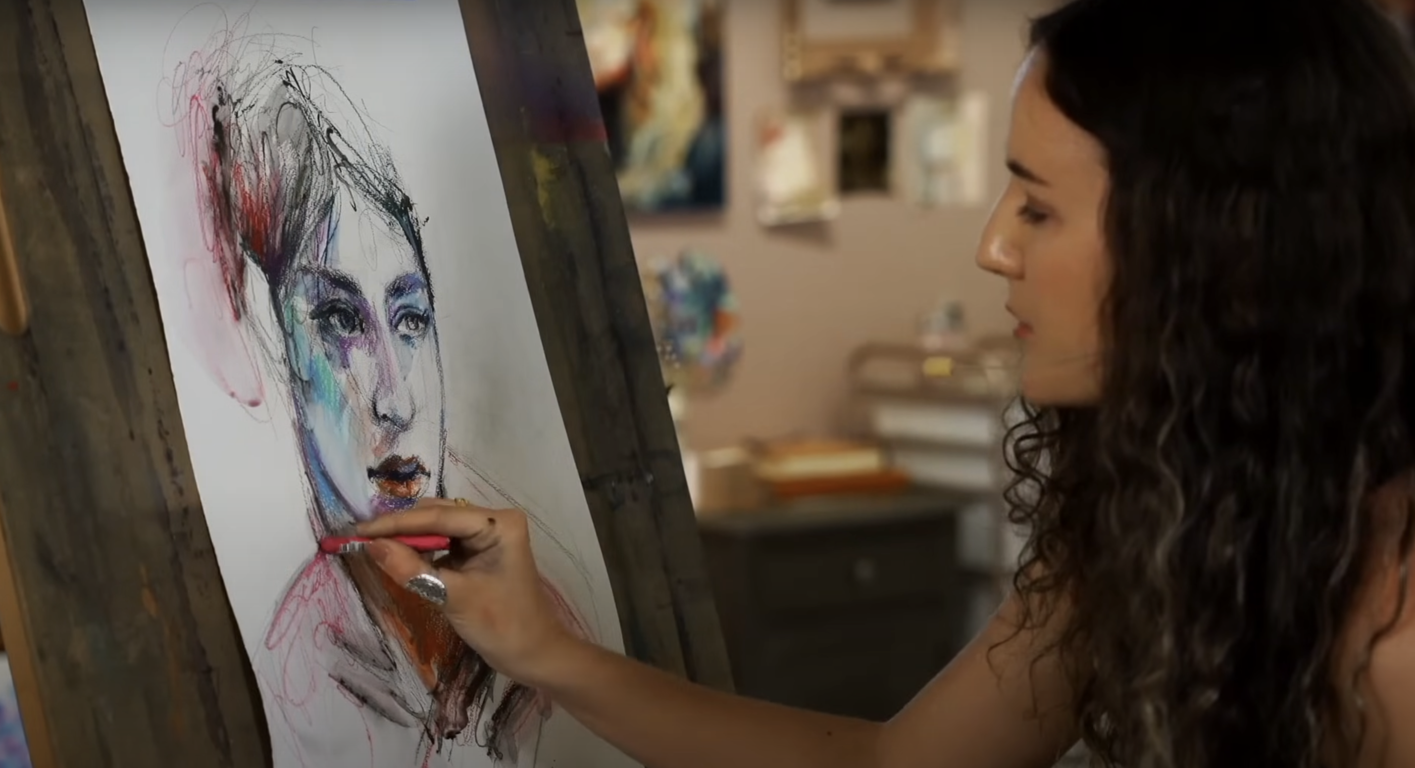 woman sketching a colorful portrait on an easel board